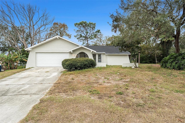 single story home featuring a garage and a front yard