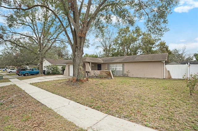 ranch-style house with a garage and a front yard