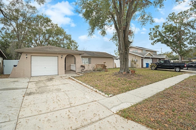 single story home featuring a garage and a front yard