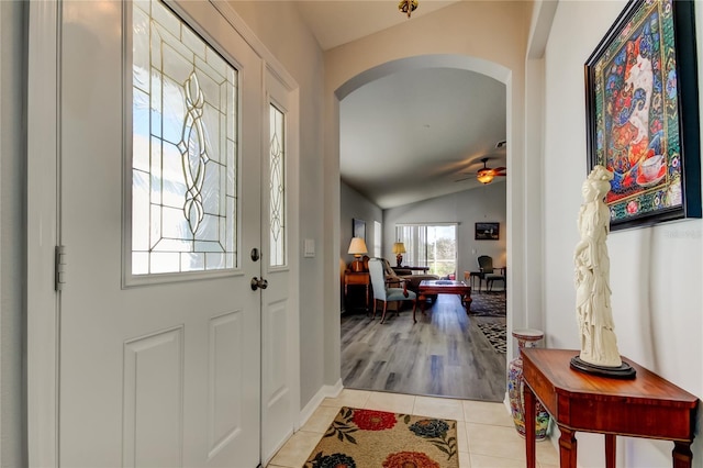 tiled foyer entrance featuring ceiling fan and vaulted ceiling