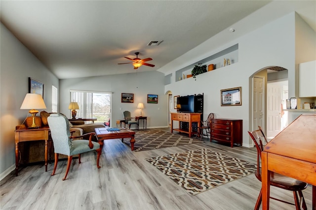 living room with light hardwood / wood-style flooring, ceiling fan, and lofted ceiling