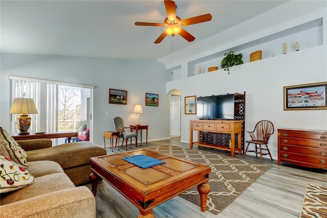 living room with ceiling fan, vaulted ceiling, and hardwood / wood-style flooring