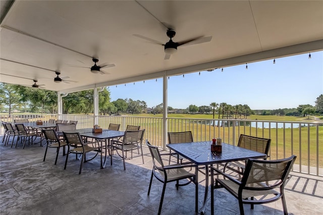 view of patio featuring ceiling fan and a water view