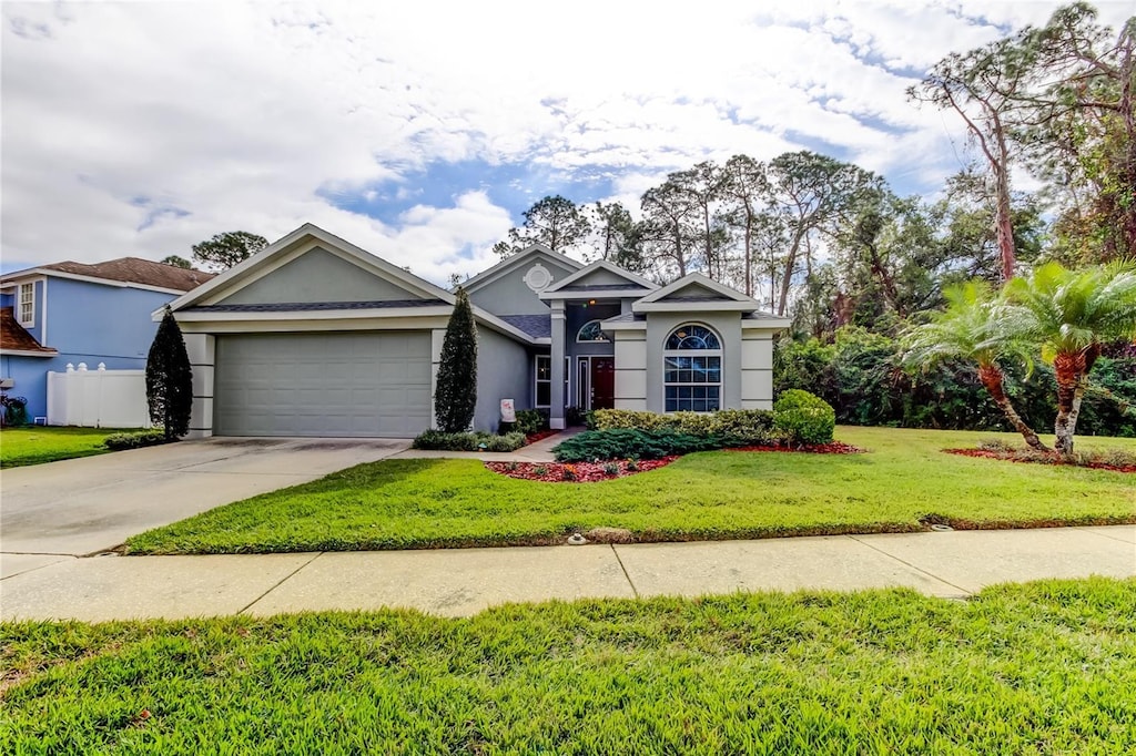 view of front of home featuring a garage and a front yard