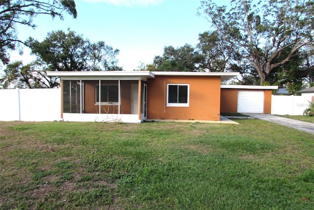 view of front facade featuring a sunroom, a front lawn, and a garage