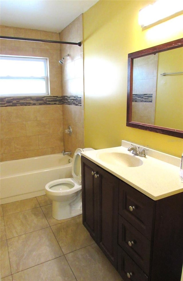 full bathroom featuring tile patterned floors, vanity, toilet, and tiled shower / bath