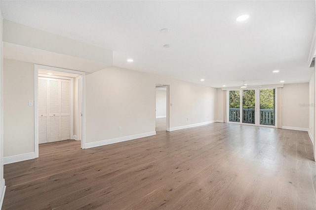 empty room with ceiling fan and hardwood / wood-style floors