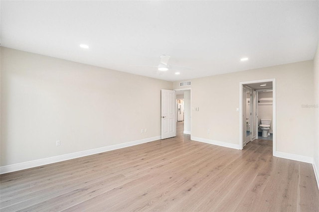 unfurnished bedroom featuring light wood-type flooring, ensuite bath, and ceiling fan