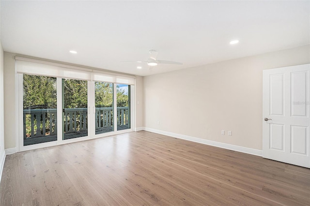 unfurnished room with ceiling fan and hardwood / wood-style flooring