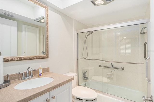 full bathroom with shower / bath combination with glass door, vanity, and toilet