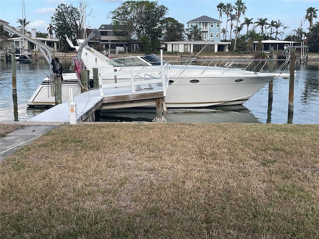 dock area with a water view and a lawn