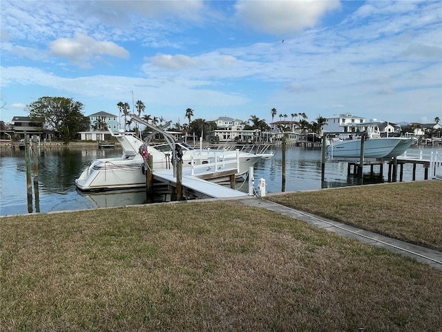 dock area with a yard and a water view