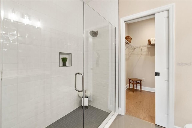 bathroom featuring tile patterned flooring and a shower with door