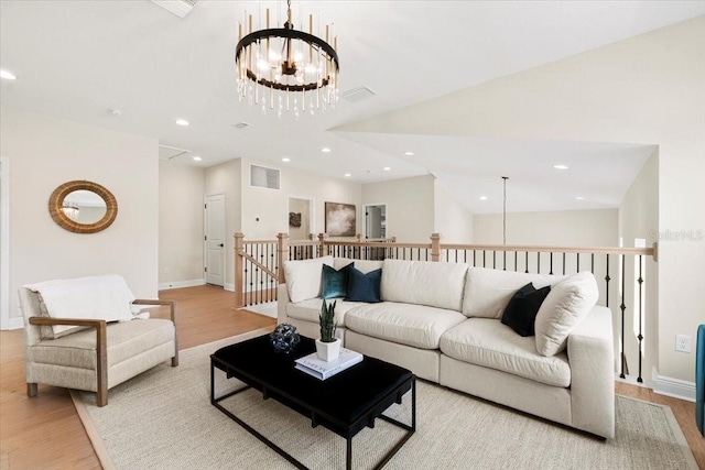 living room with a notable chandelier and light hardwood / wood-style floors