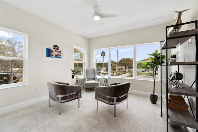 sitting room featuring ceiling fan and light carpet