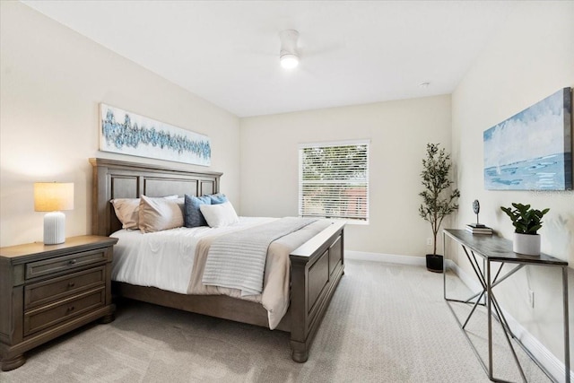 bedroom with ceiling fan and light colored carpet