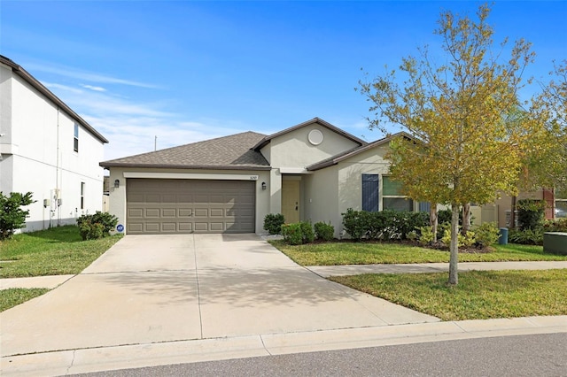 view of front of property featuring a front lawn and a garage