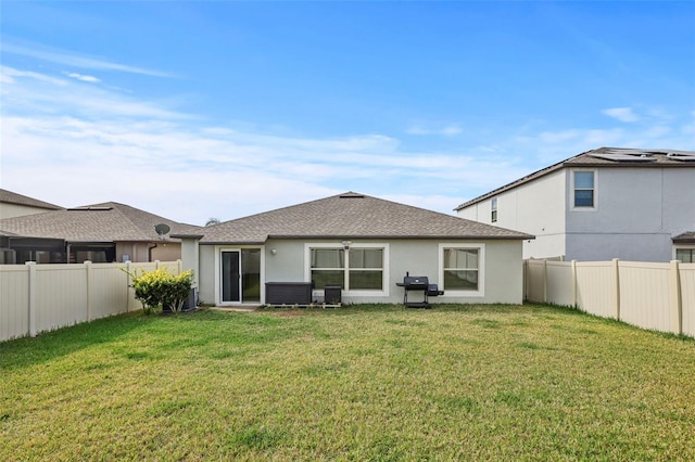 rear view of property with a yard