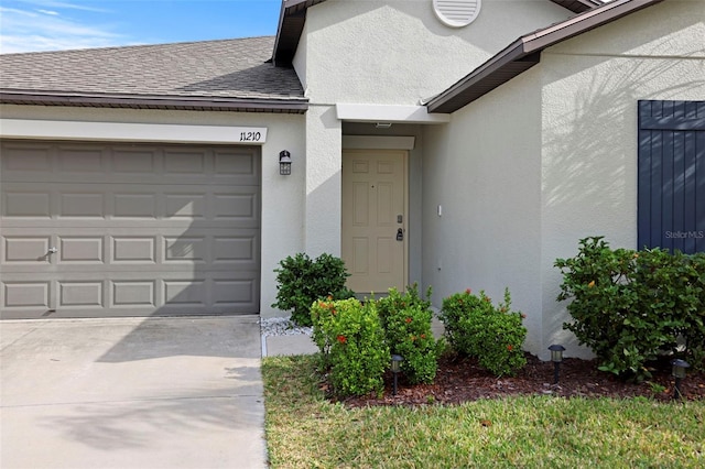 view of exterior entry with a garage