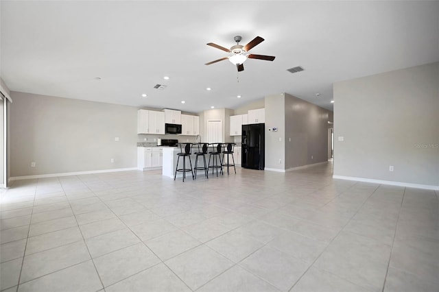 unfurnished living room featuring light tile patterned floors and ceiling fan