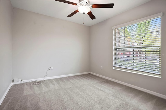 empty room with ceiling fan and light colored carpet