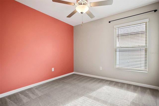 carpeted spare room with plenty of natural light and ceiling fan