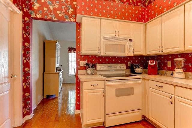 kitchen featuring light wood-type flooring and white appliances