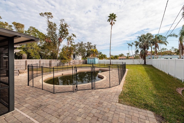 view of swimming pool with a yard