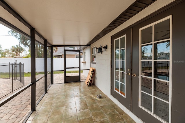 unfurnished sunroom featuring french doors