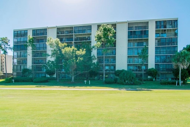 view of property's community with a lawn