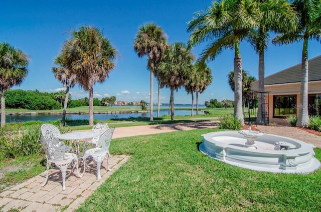 view of yard featuring a water view and a patio