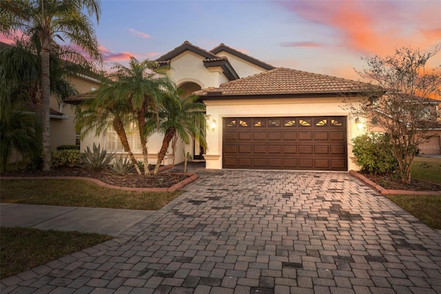 mediterranean / spanish-style house featuring a garage