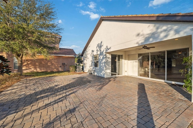 back of property with a patio area and ceiling fan