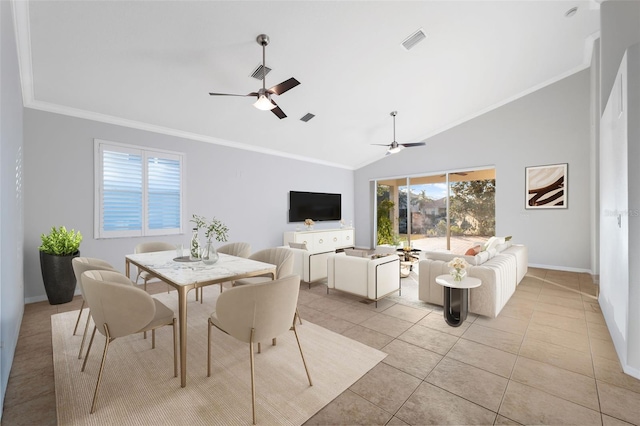 tiled dining area with ceiling fan, a healthy amount of sunlight, lofted ceiling, and ornamental molding