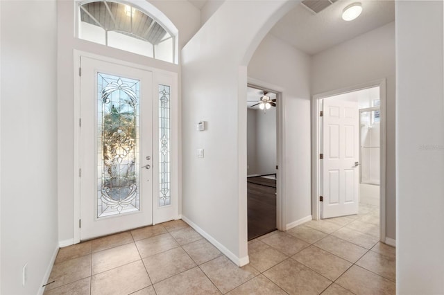 tiled foyer entrance featuring ceiling fan