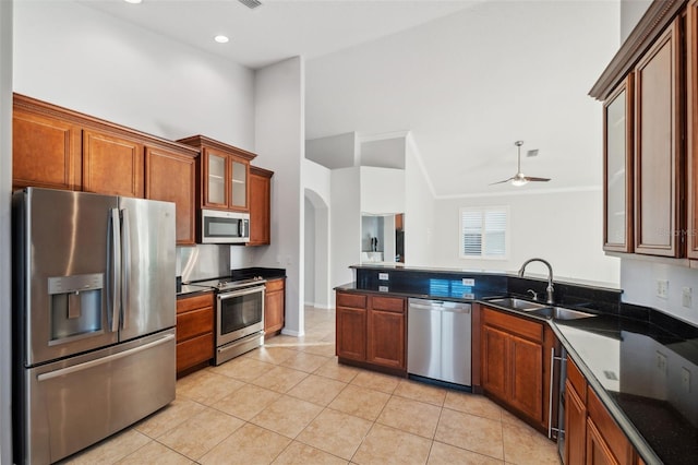 kitchen featuring ceiling fan, sink, light tile patterned flooring, and appliances with stainless steel finishes