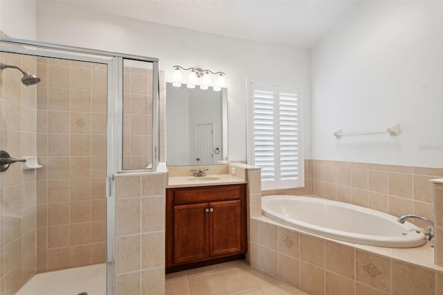 bathroom with tile patterned flooring, vanity, and separate shower and tub