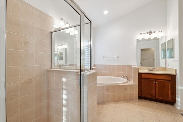 bathroom with tile patterned flooring, vanity, and separate shower and tub