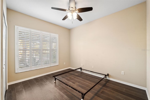 unfurnished bedroom with ceiling fan and dark hardwood / wood-style floors