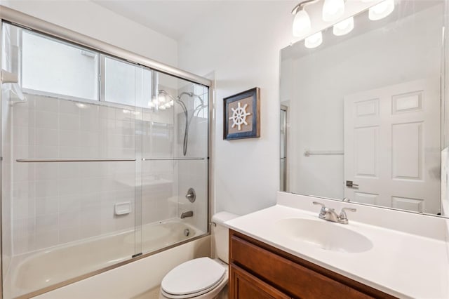 full bathroom with shower / bath combination with glass door, vanity, and toilet