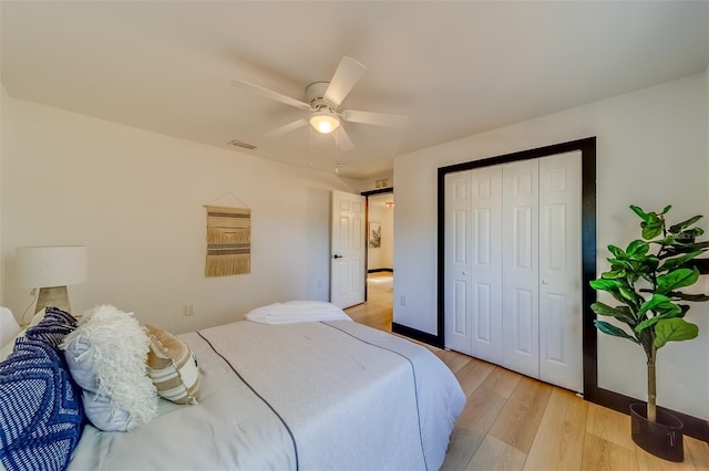 bedroom featuring ceiling fan, a closet, and light hardwood / wood-style flooring