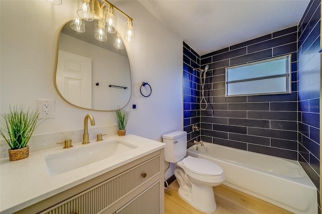 full bathroom featuring wood-type flooring, vanity, toilet, and tiled shower / bath