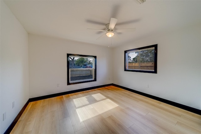 empty room featuring ceiling fan and light hardwood / wood-style floors