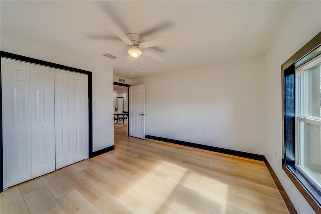 unfurnished bedroom featuring ceiling fan, a closet, and light hardwood / wood-style floors