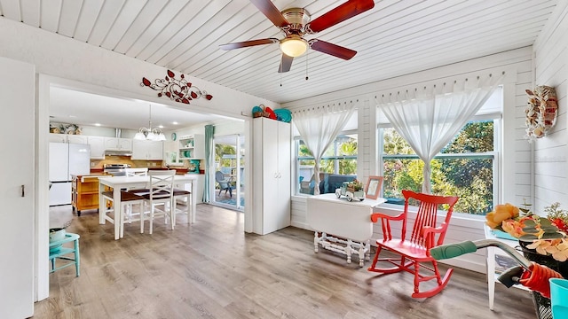 sunroom with ceiling fan with notable chandelier, plenty of natural light, and wood ceiling