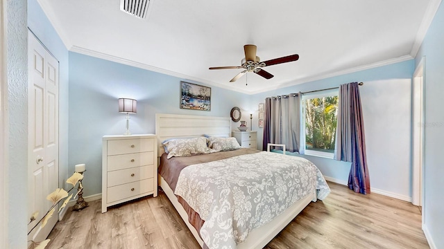 bedroom with a closet, ceiling fan, crown molding, and light wood-type flooring