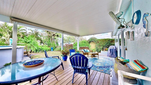 wooden terrace with an outdoor living space