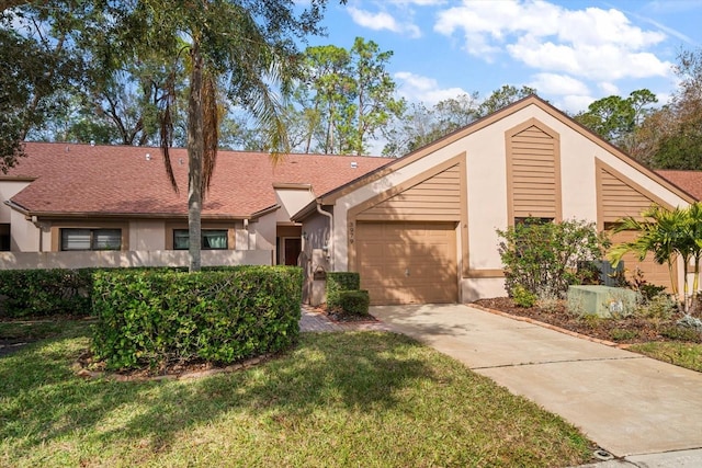 single story home with a front yard and a garage