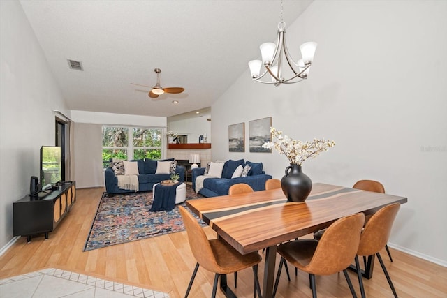 dining space featuring ceiling fan with notable chandelier, light hardwood / wood-style floors, and a textured ceiling