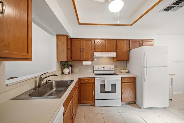 kitchen featuring backsplash, sink, light tile patterned floors, and white appliances